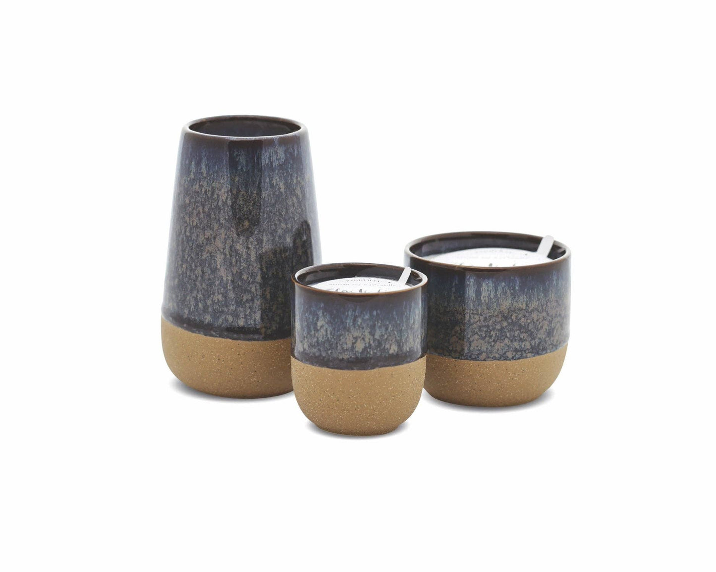 Three ceramic candles with a dark gray top and beige base on a white background