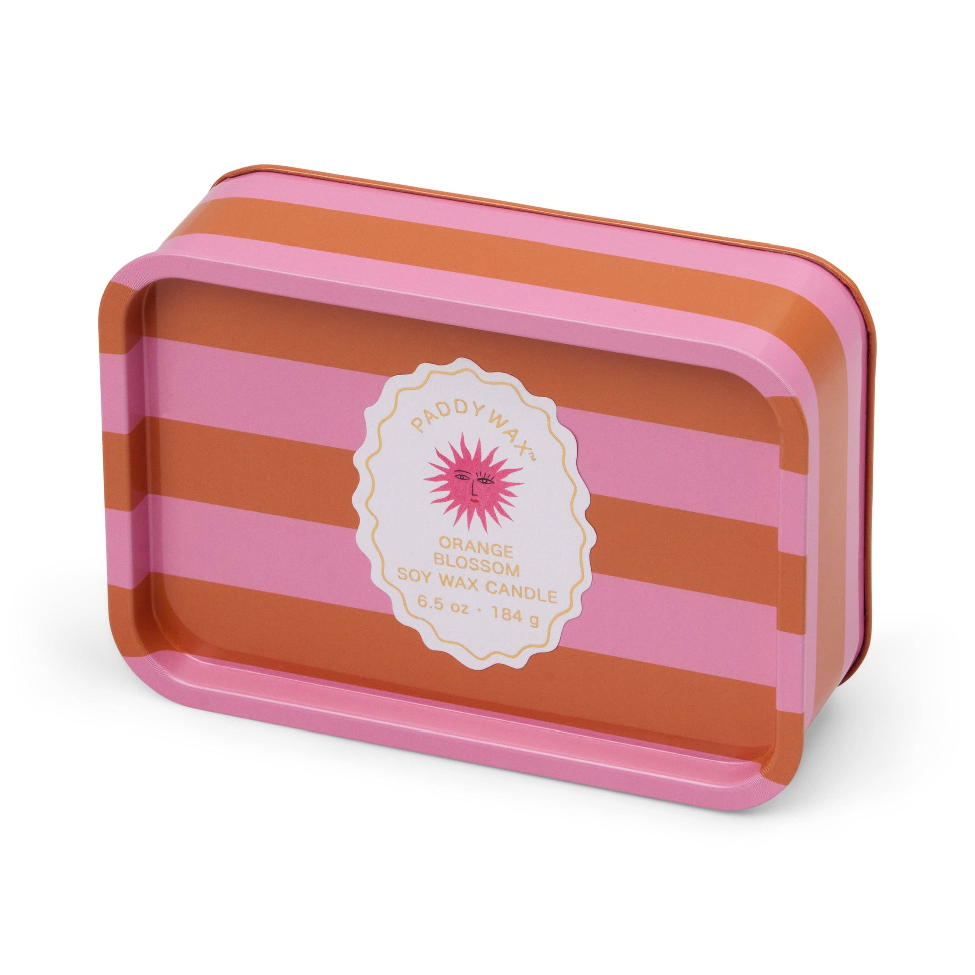 Striped pink and orange candle tin with a label on a white background