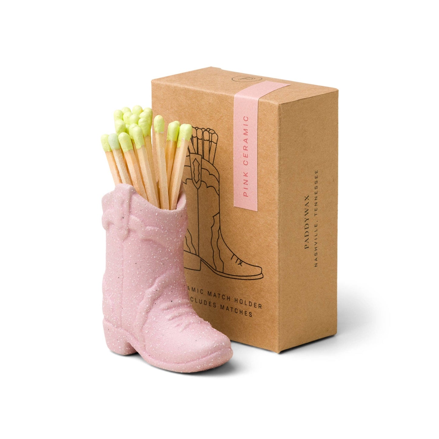 Pink boot-shaped match holder with matches and a matching box on a white background
