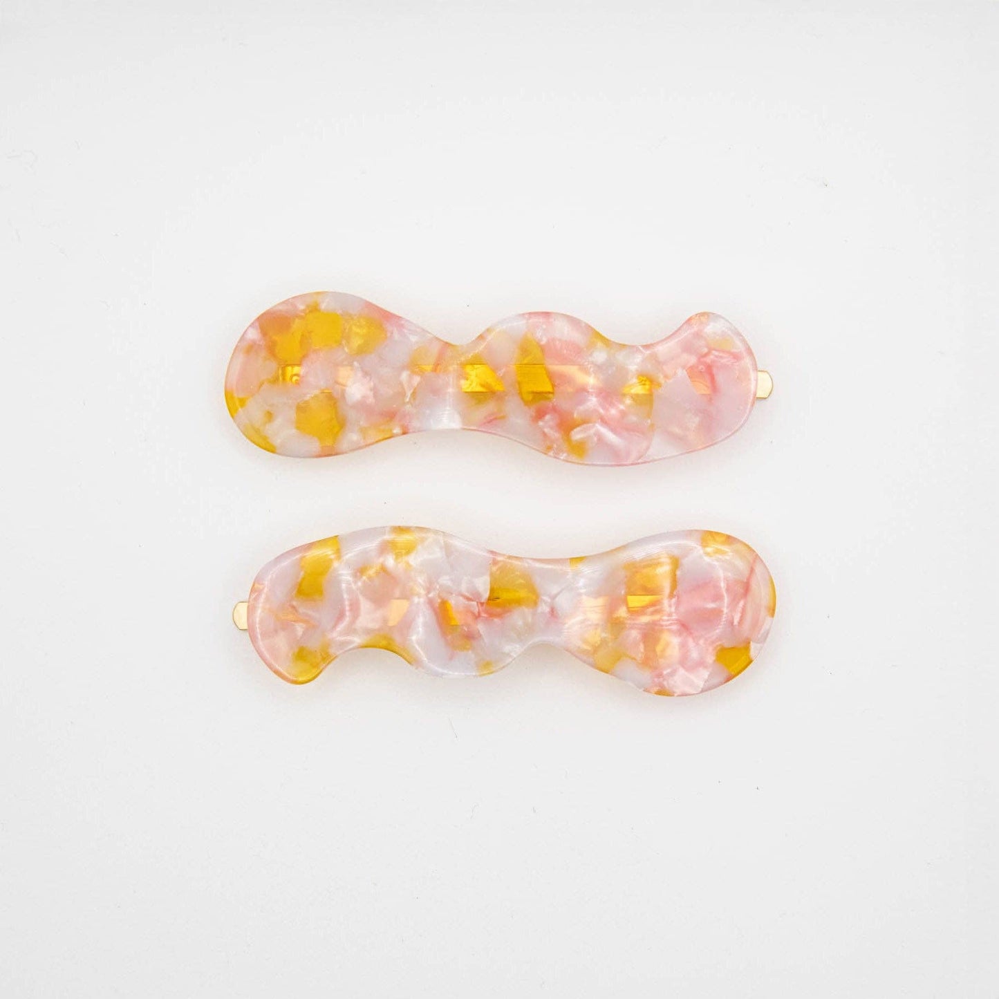 Two colorful hair clips on a white background