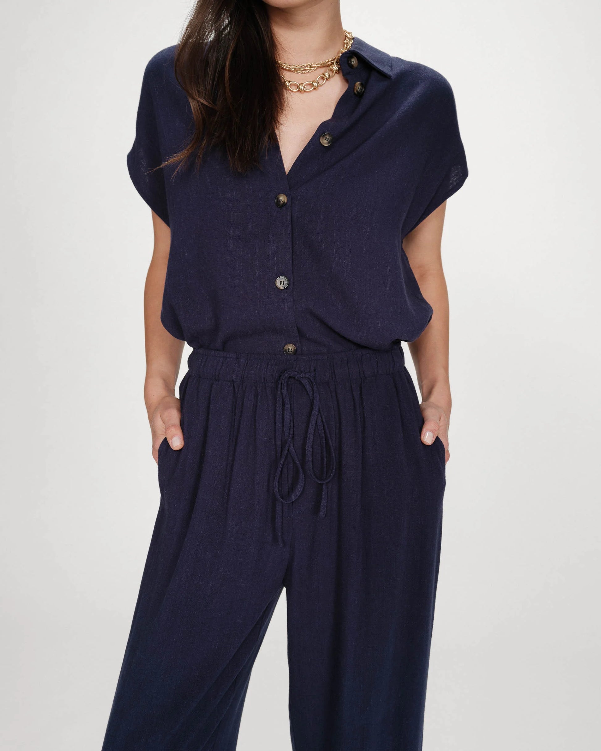 Navy blue outfit with a top and pants on a plain background