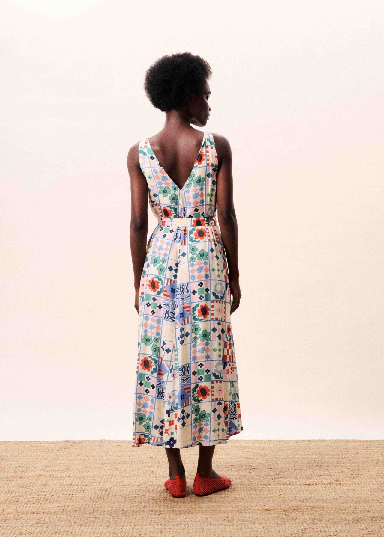 Woman wearing a floral dress with a plain background