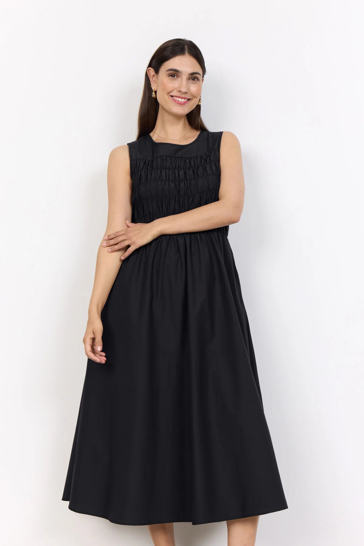 model in a black dress on a white background