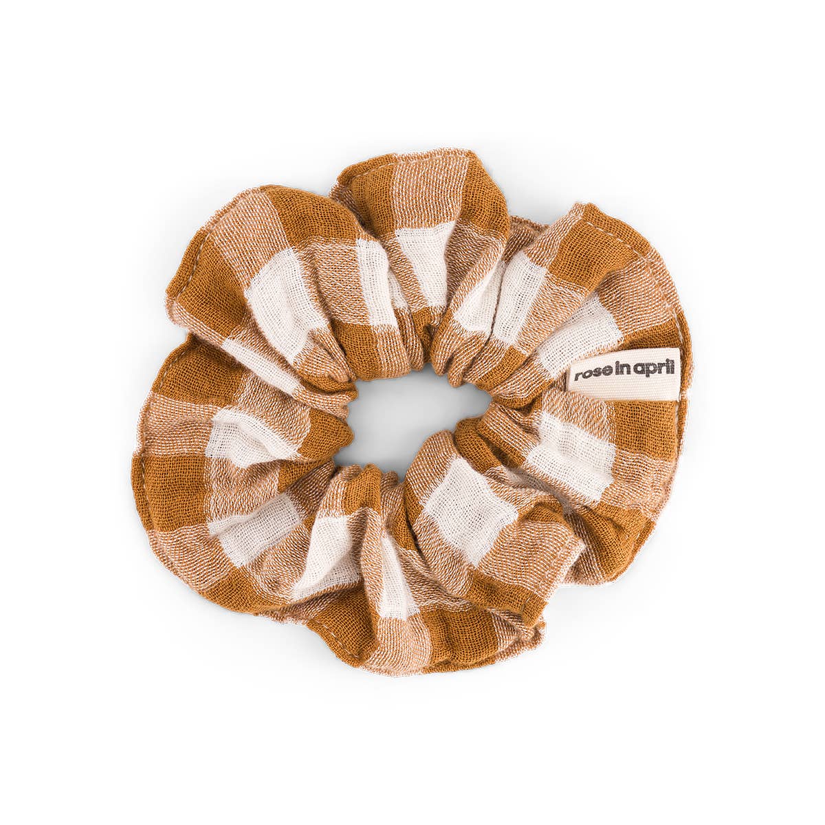 Brown and white checkered scrunchie with 'rose in april' branding on a white background