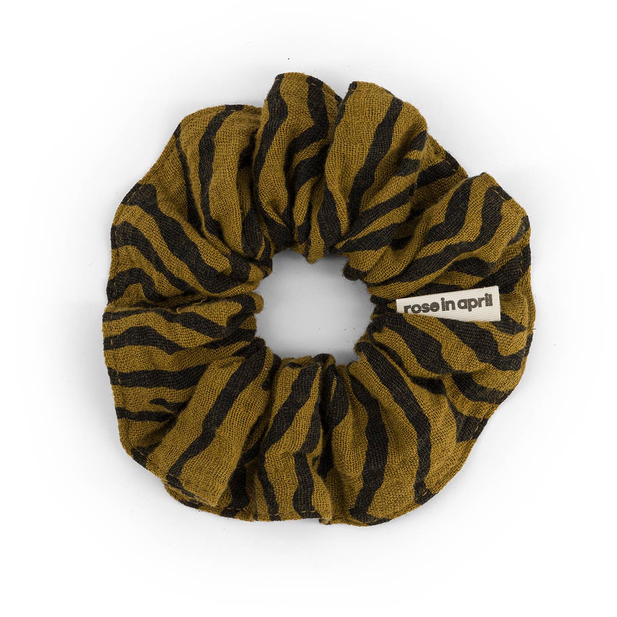 Zebra patterned scrunchie with 'rose in april' label on a white background
