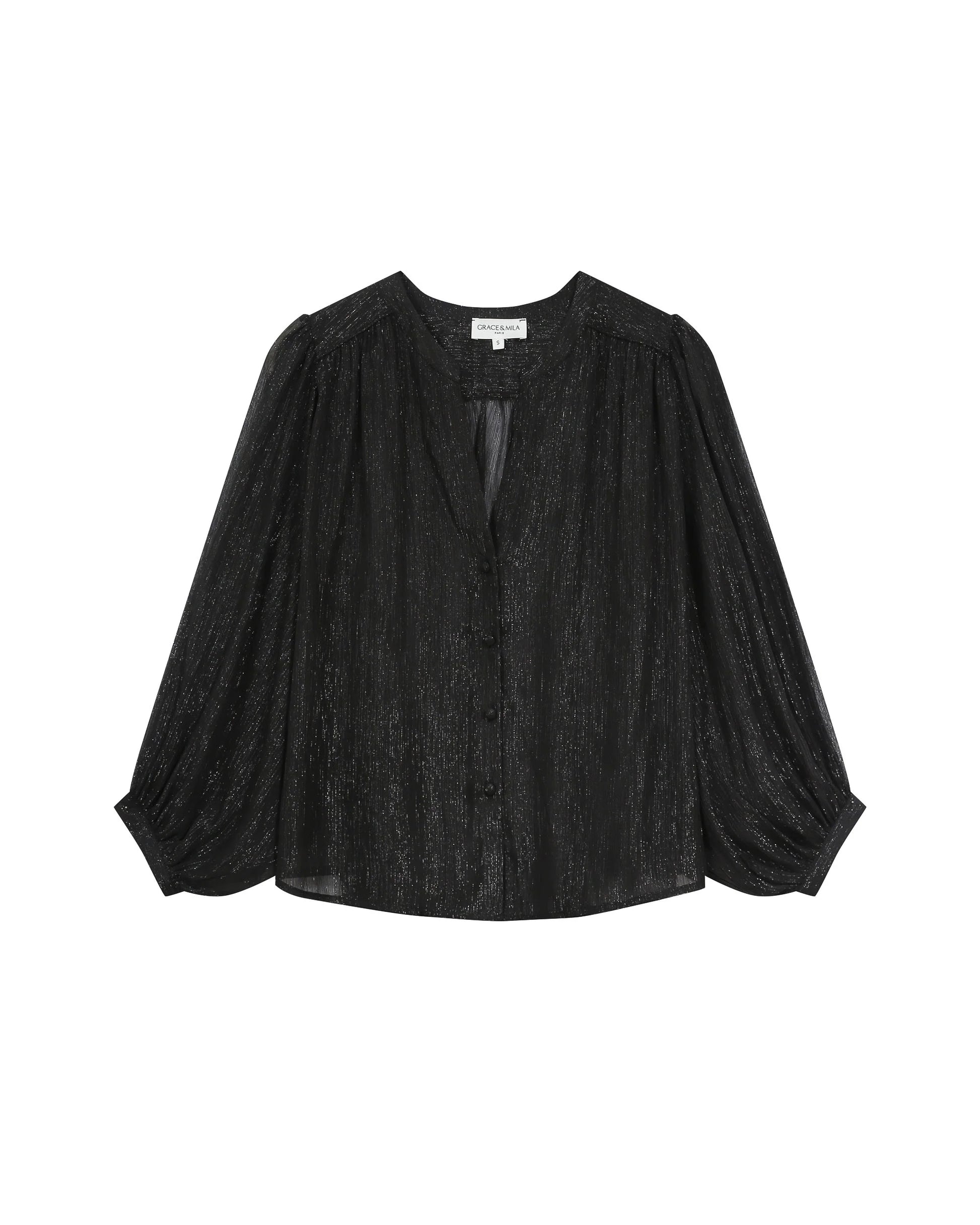 Black blouse with sheer details on a white background
