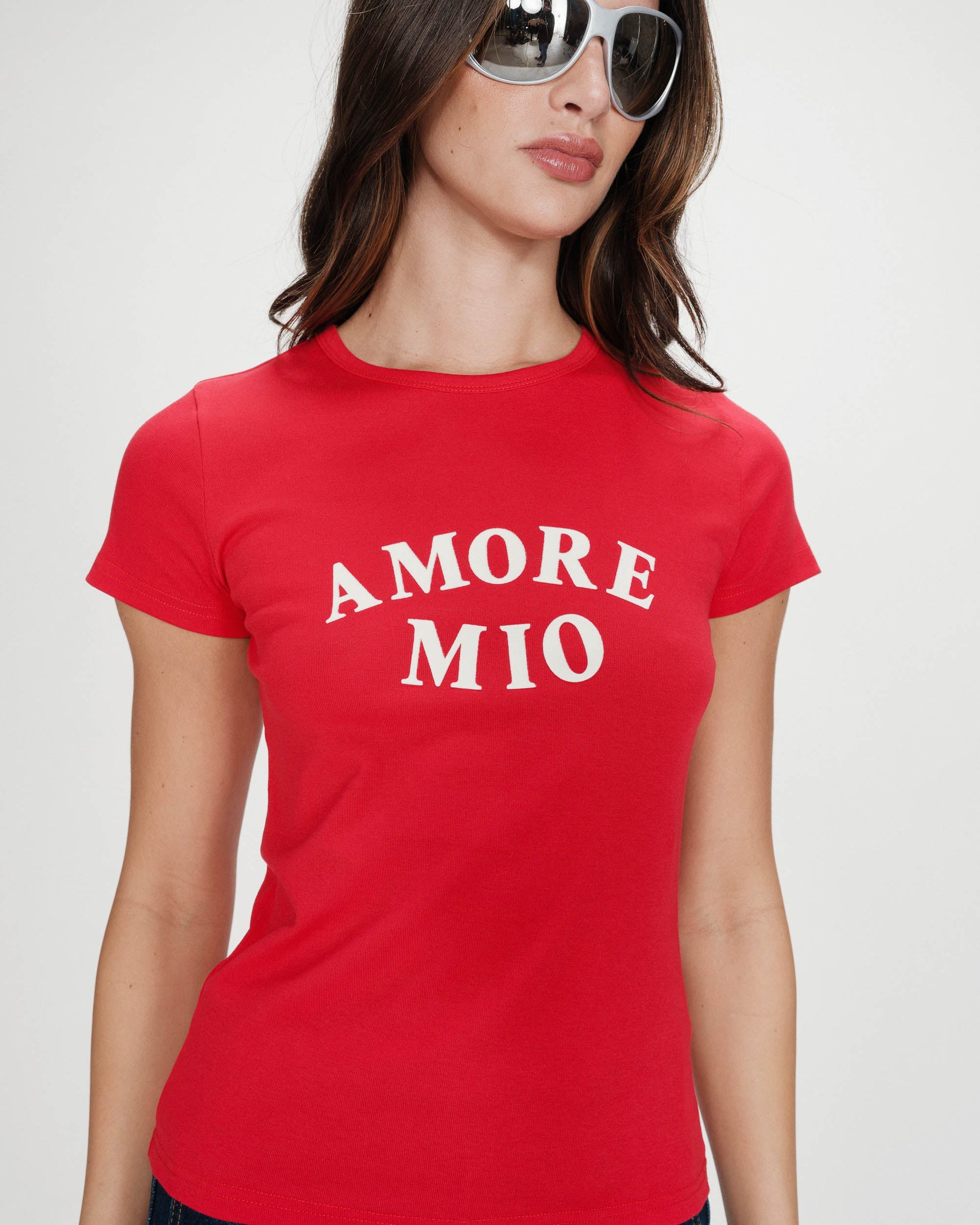 Woman wearing a red t-shirt with 'AMORE MIO' text on a white background