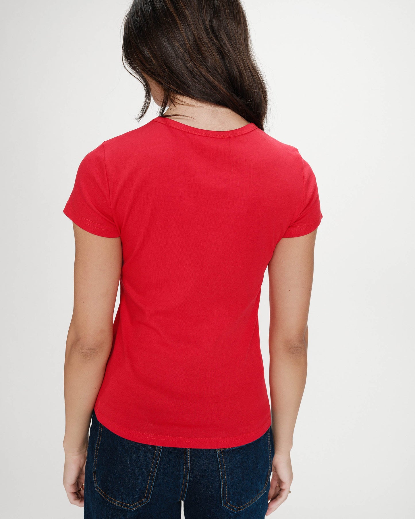 Person wearing a red t-shirt on a plain background