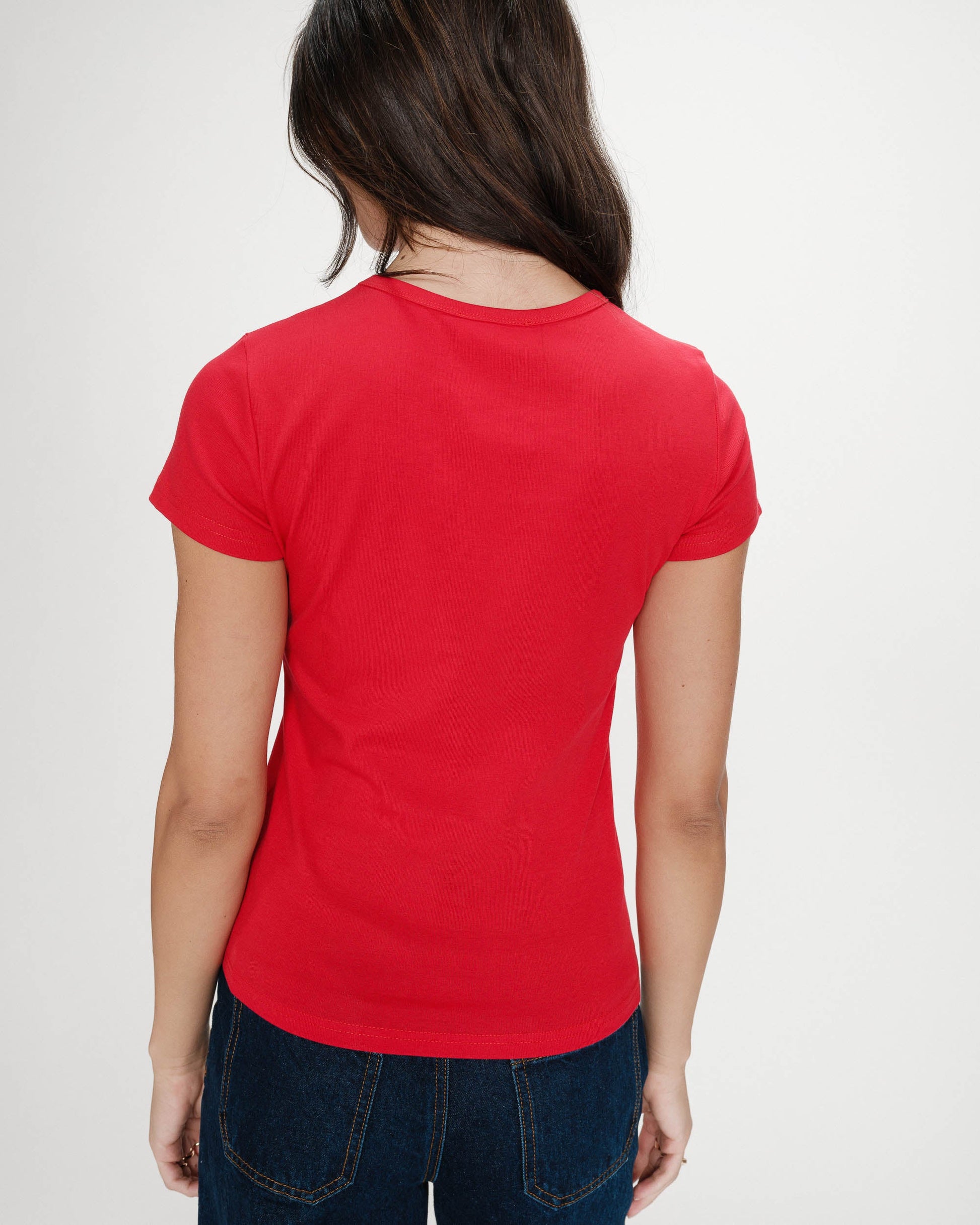 Person wearing a red t-shirt on a plain background