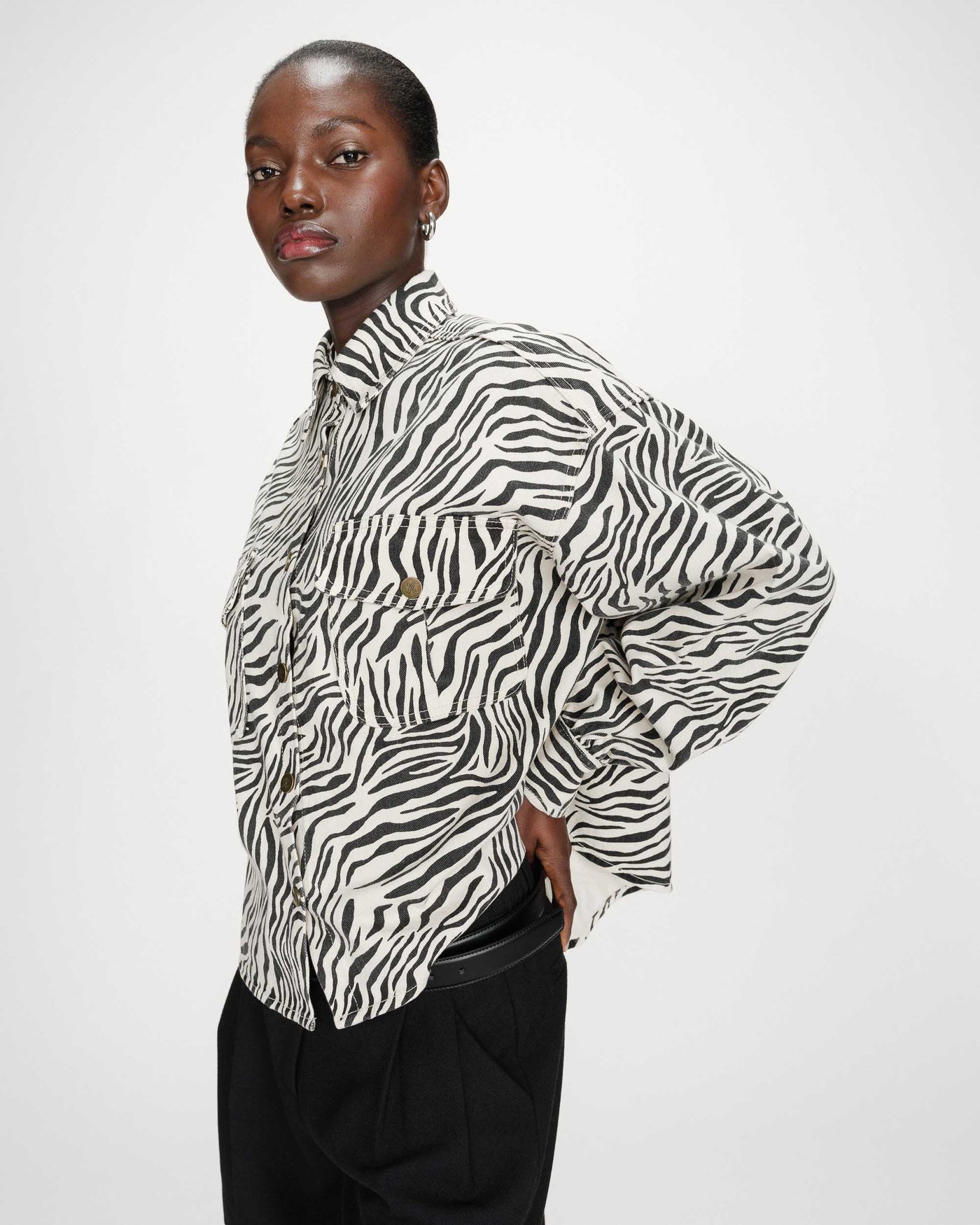 Person wearing a zebra print shirt against a white background