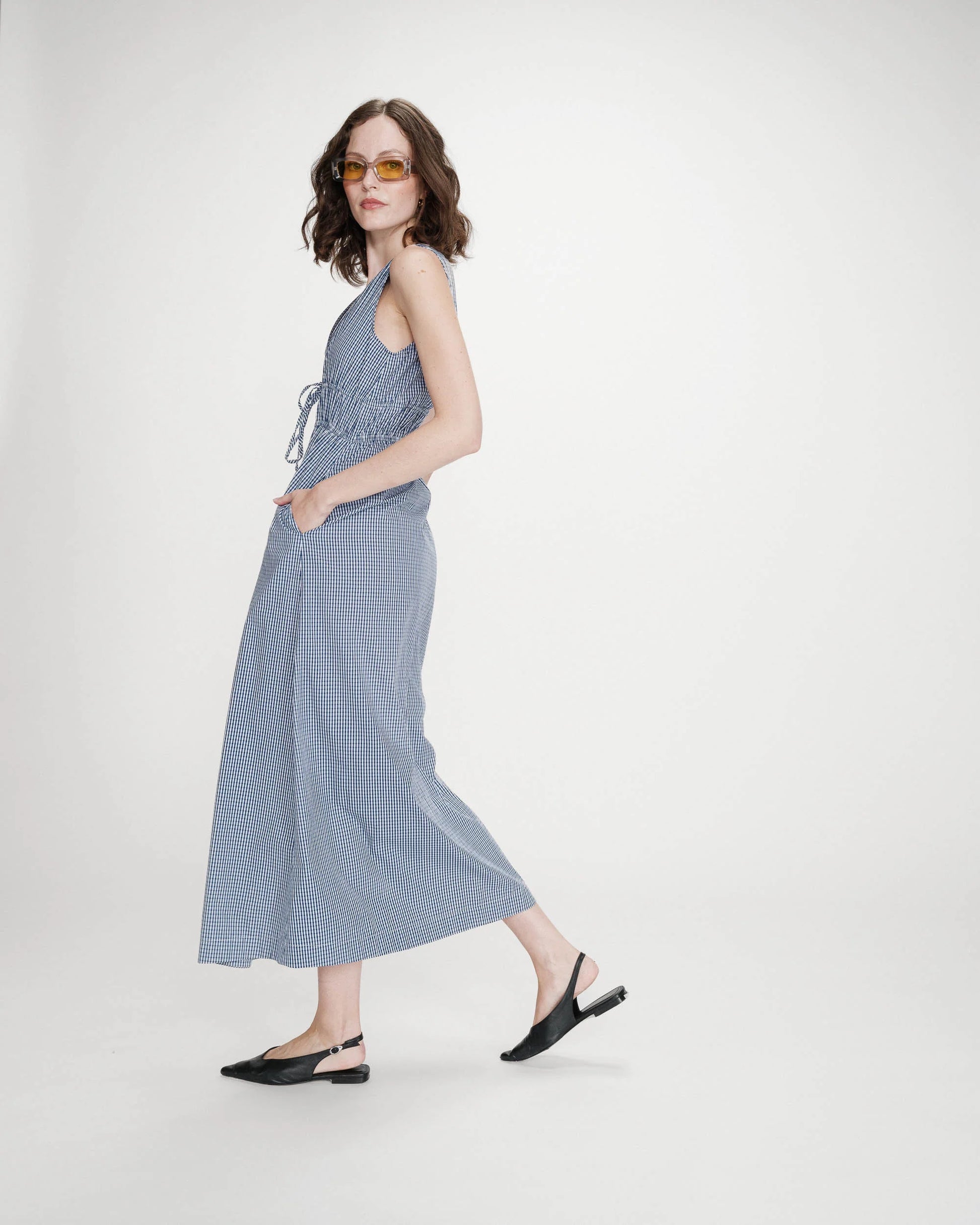 Woman wearing a blue dress with a white background
