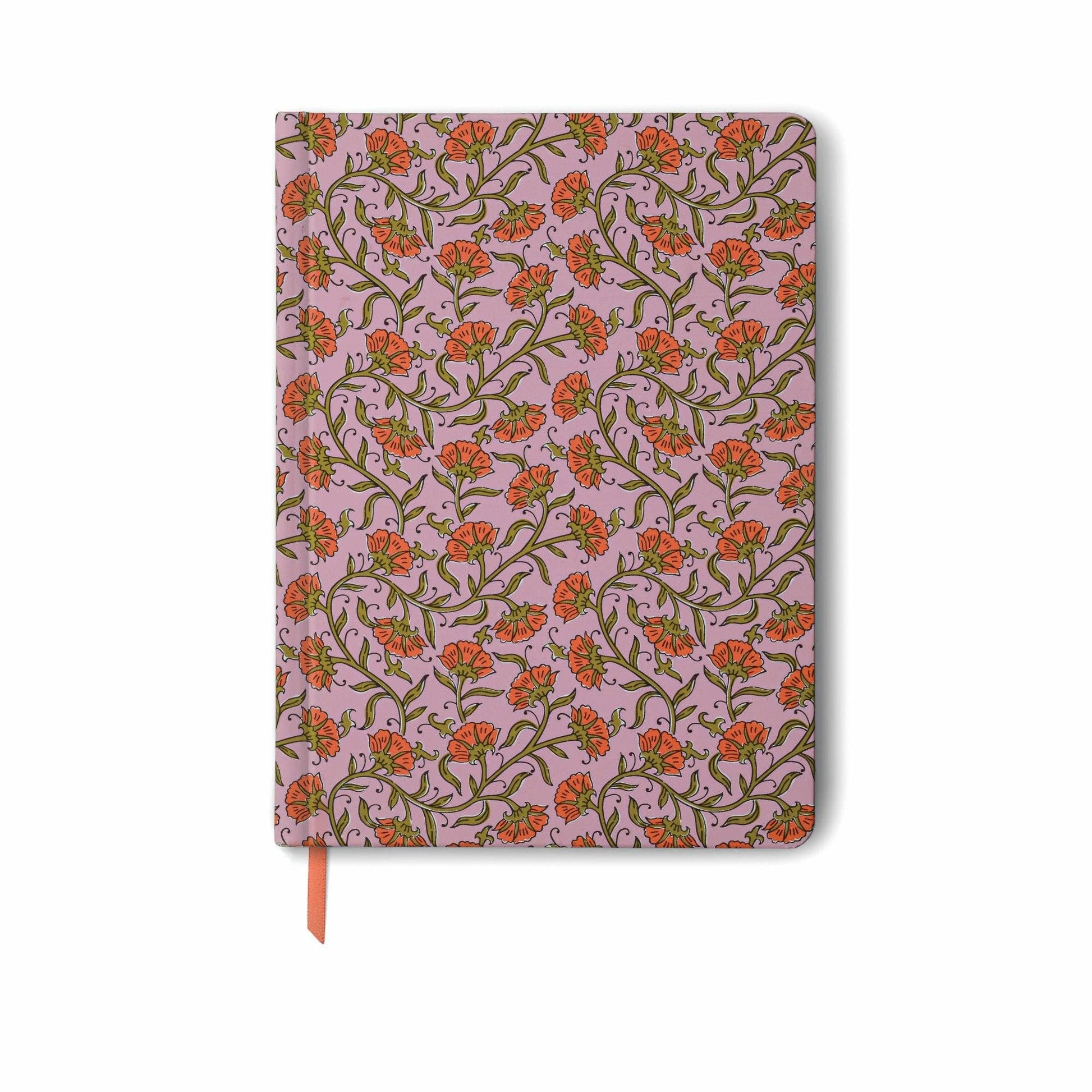 Notebook with floral pattern on a pink background