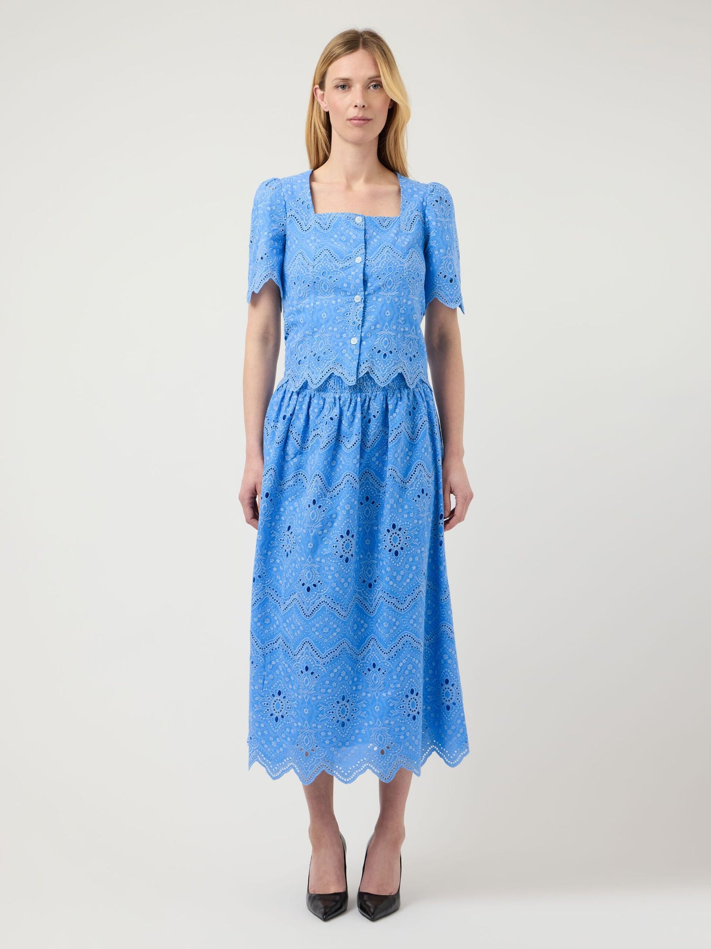 Woman wearing a blue dress with a white background