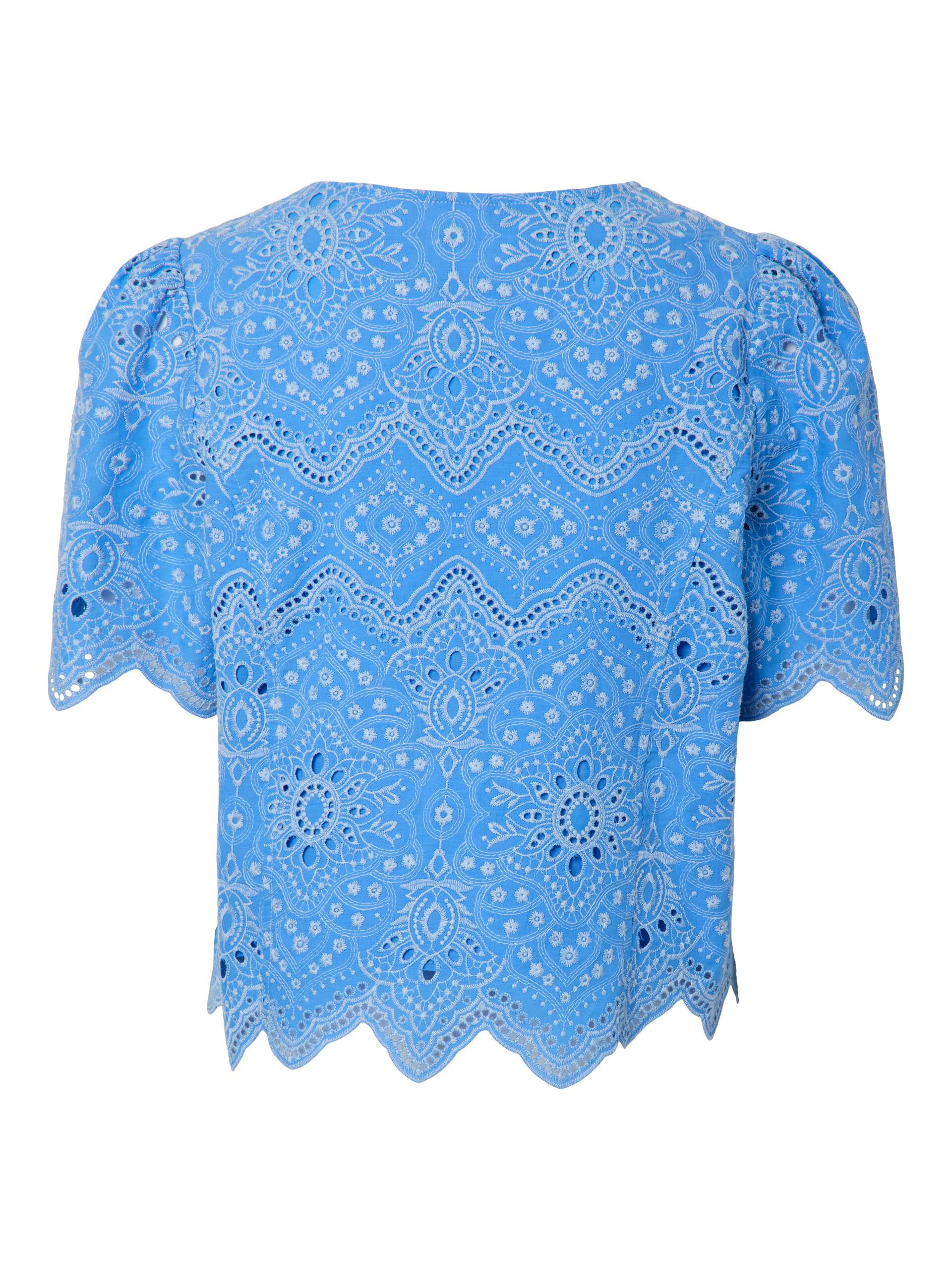 Blue blouse with intricate white patterns on a white background