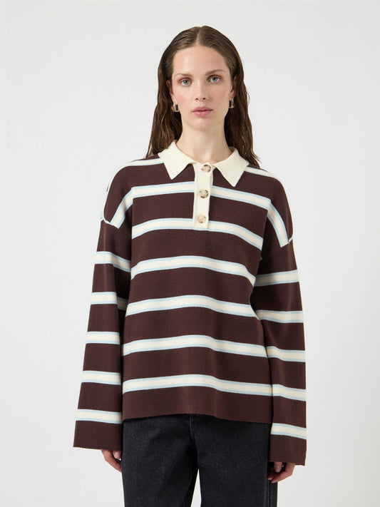 Woman wearing a brown and white striped sweater on a white background