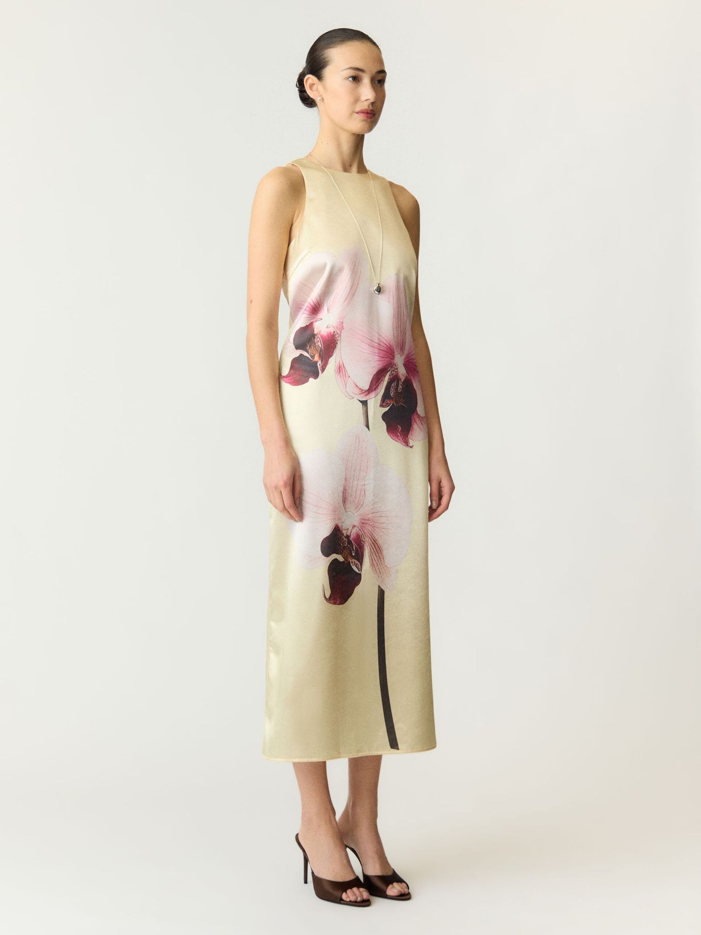 Woman wearing a floral dress on a white background