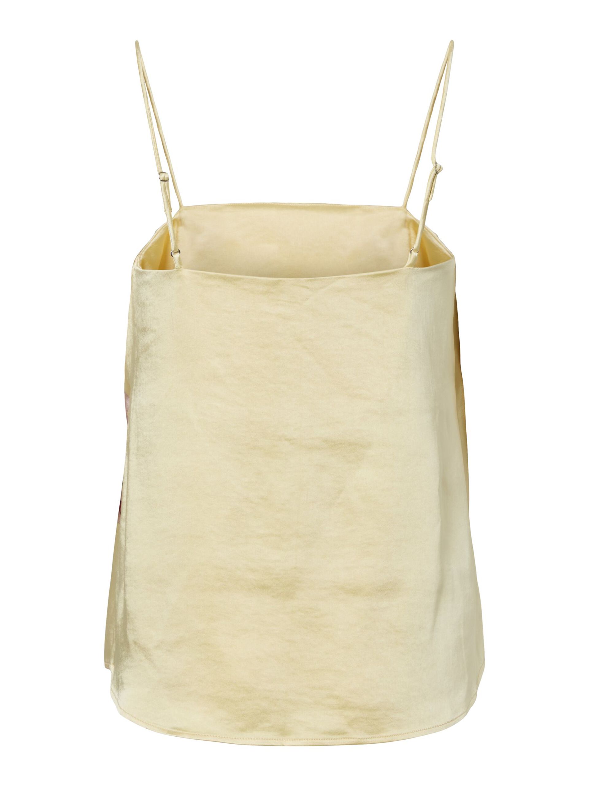 Pale yellow strappy top on a white background