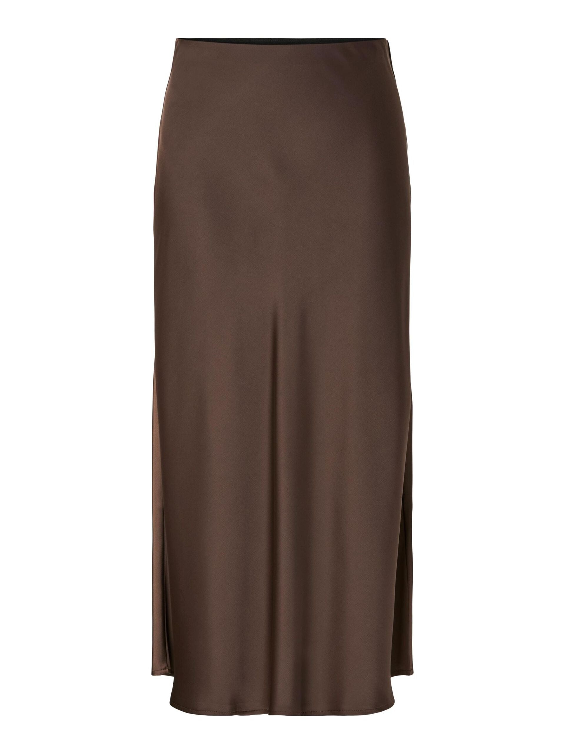 Woman wearing a brown skirt and beige top on a white background