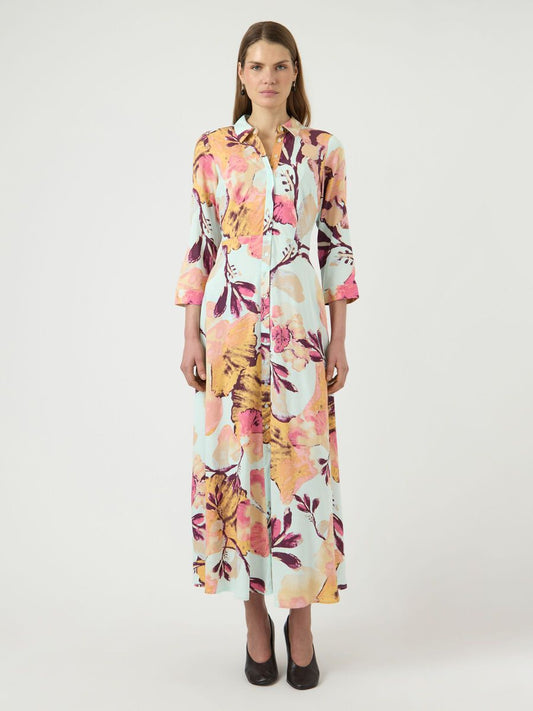 Woman wearing a colorful floral dress on a white background