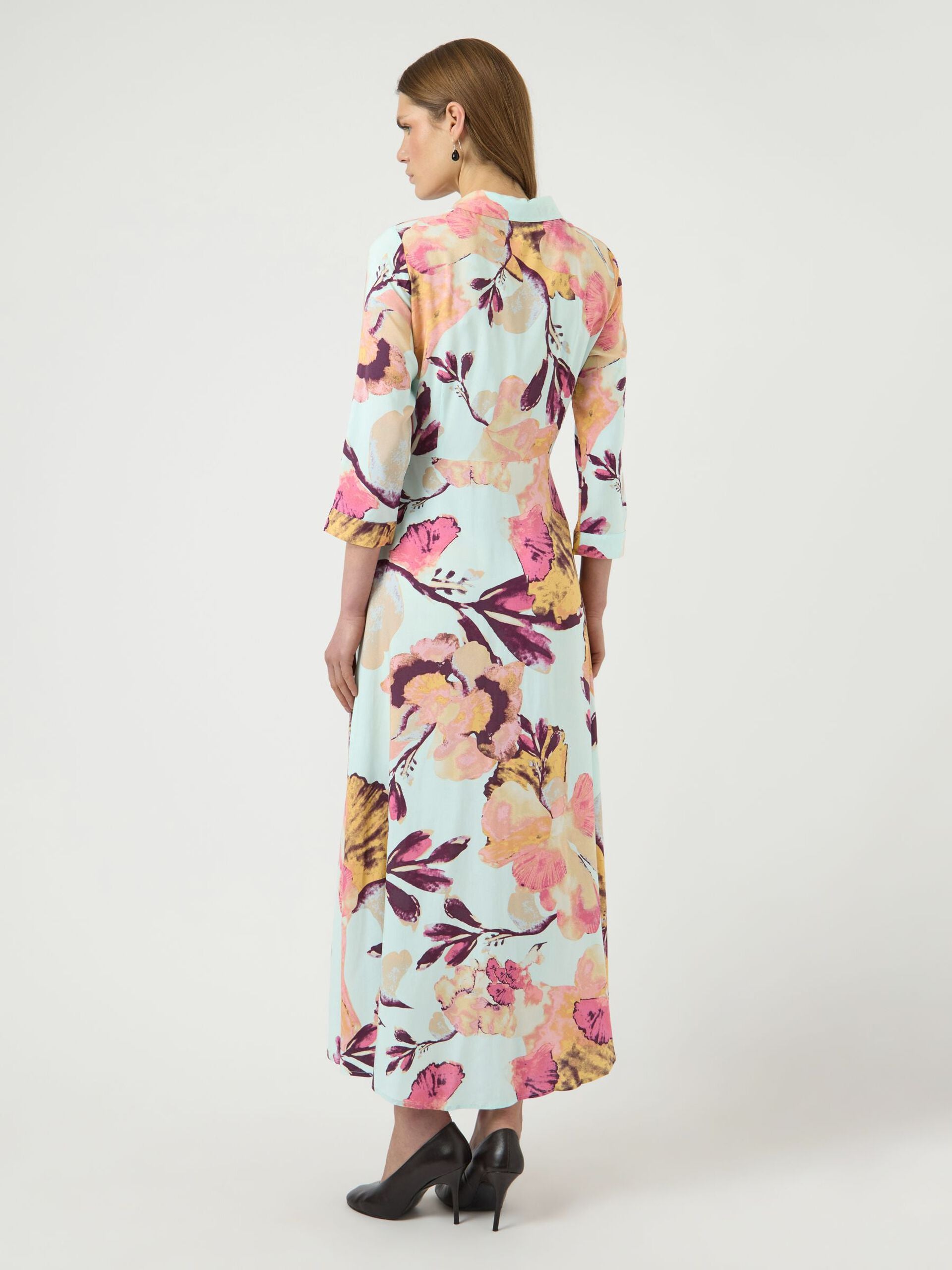 Woman wearing a floral dress on a white background