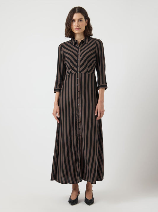 Woman wearing a black and brown striped dress on a white background