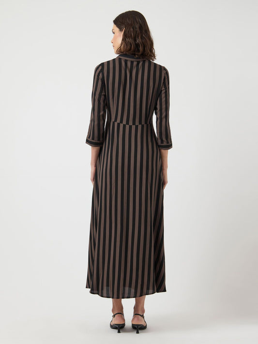 Woman wearing a black and brown striped dress on a white background