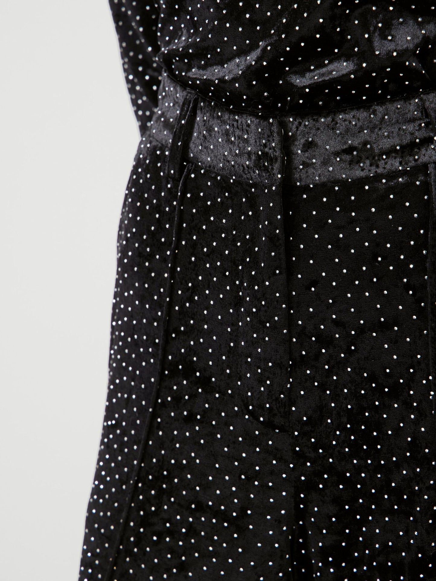 close up of velvet trousers with rhinestones