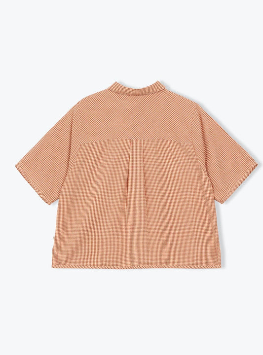 Back view of a peach-colored checkered shirt on a white background