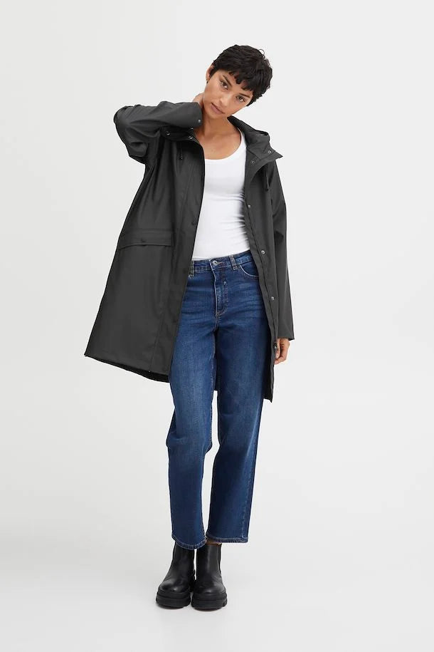 person in a black raincoat with a white background