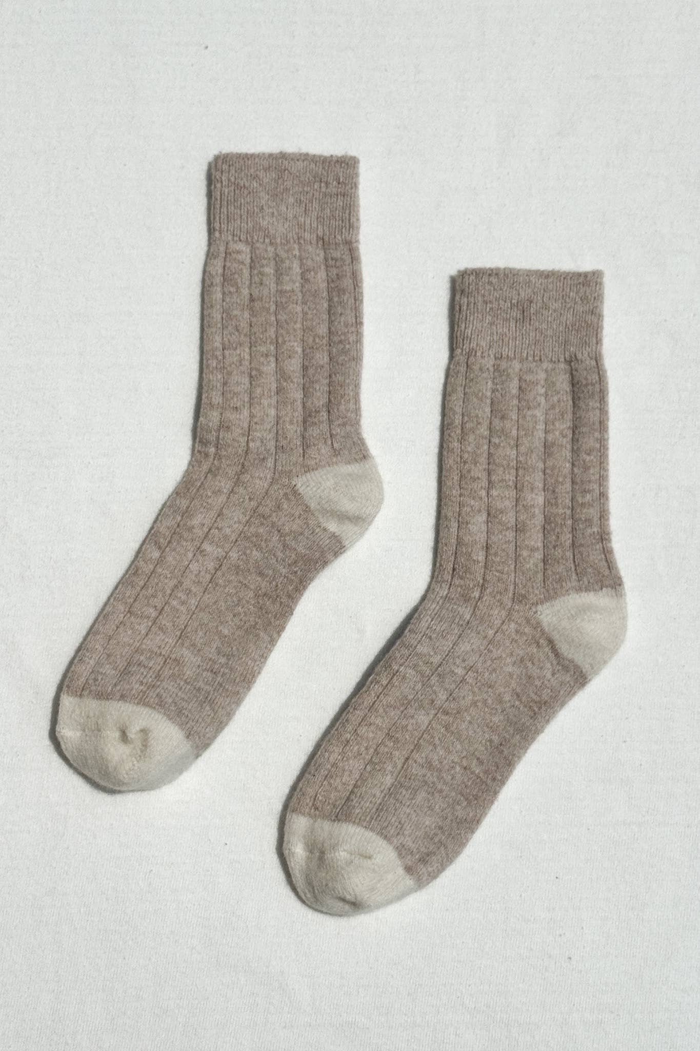 Pair of brown socks on a light gray background