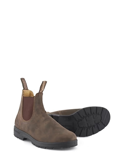 A pair of brown Chelsea boots with dark brown elastic side panels and black soles, shown on a plain white background with one boot standing upright and the other lying on its side to display the sole.