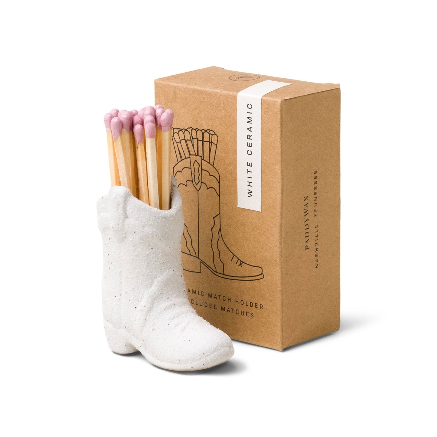 White ceramic boot-shaped match holder with matches and a cardboard box on a white background