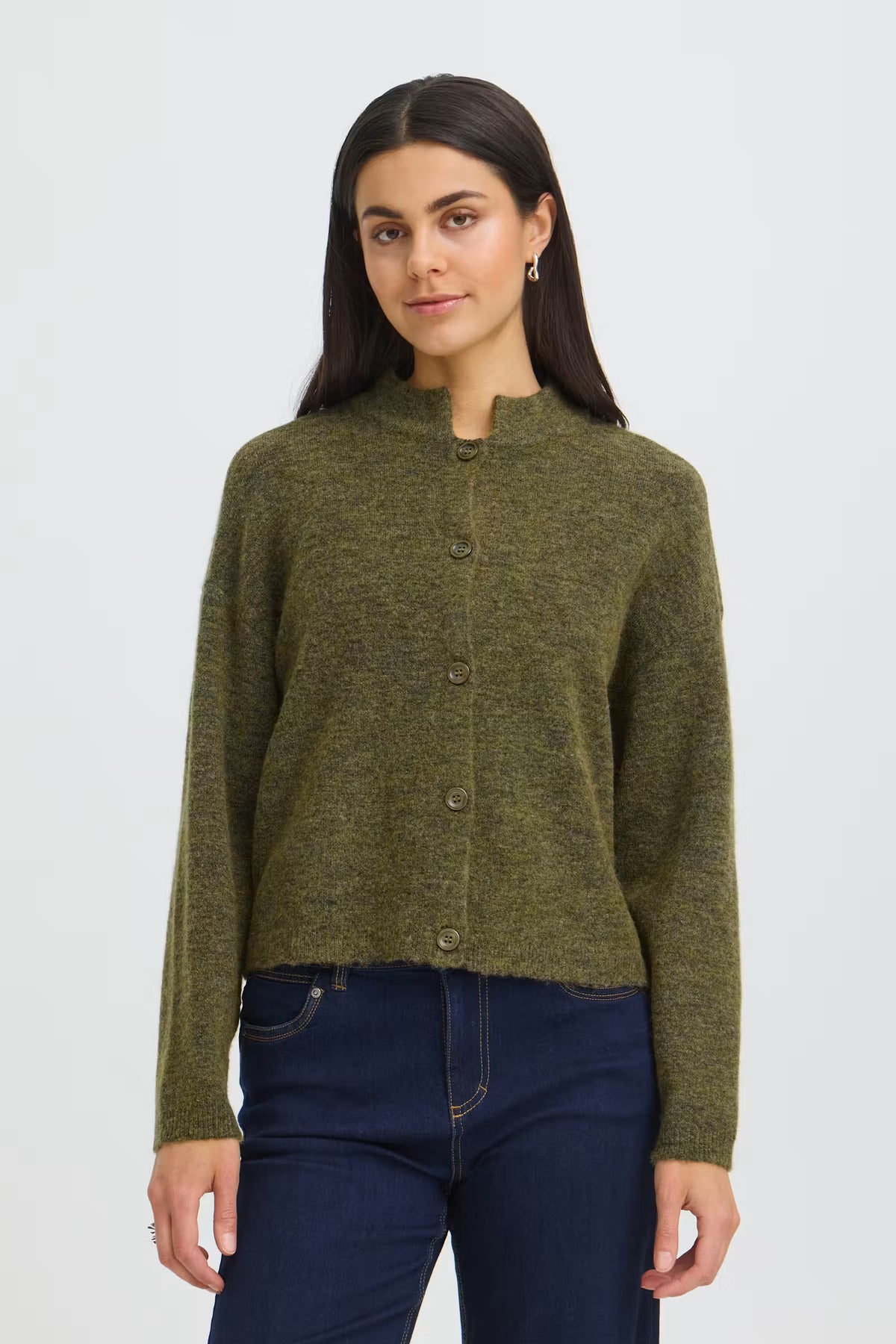 A woman modeling a short-sleeve knit cardigan in olive green with a button-front closure and stand collar, paired with dark blue jeans against a light gray studio background.