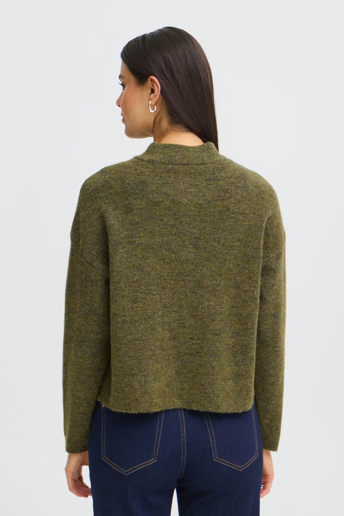 A woman shown from the back wearing a cropped, long-sleeve knit sweater in a heathered olive green color, paired with dark blue jeans, against a light gray studio background.