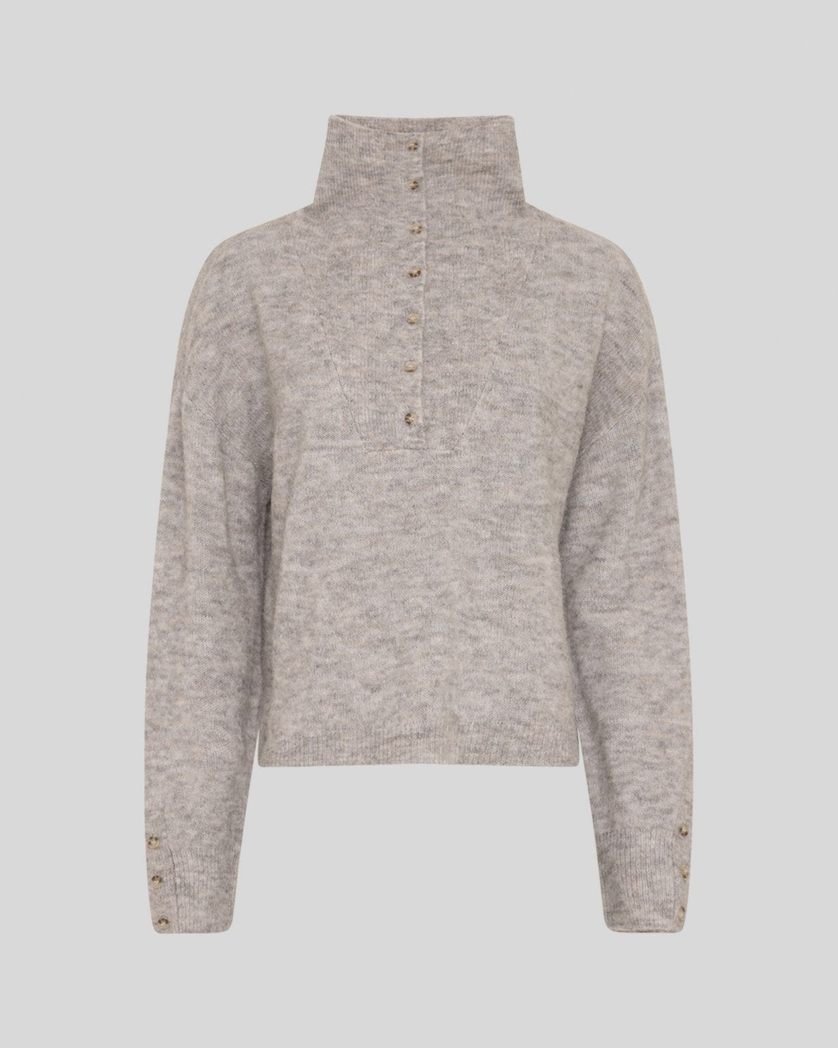 A light beige heathered knit sweater with a mock neck and a buttoned placket down the front, displayed on a neutral gray background.