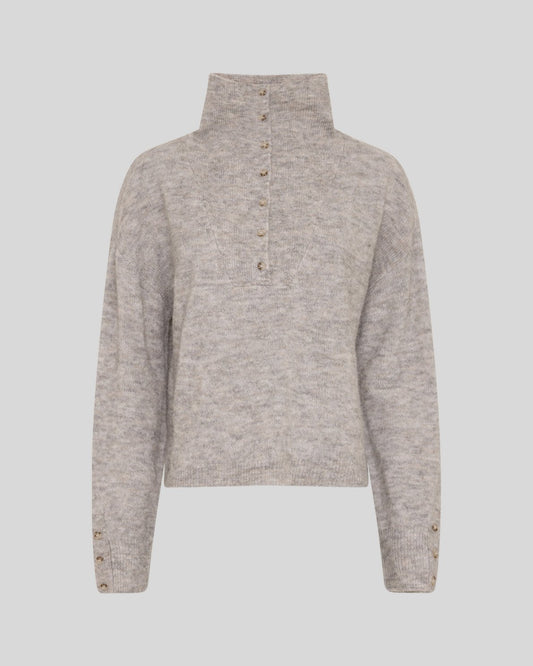 A light beige heathered knit sweater with a mock neck and a buttoned placket down the front, displayed on a neutral gray background.