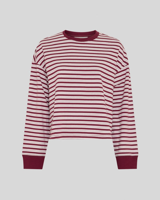 A cropped long-sleeve crewneck top with horizontal burgundy and white stripes, featuring solid burgundy ribbed cuffs and collar, shown against a solid gray background.
