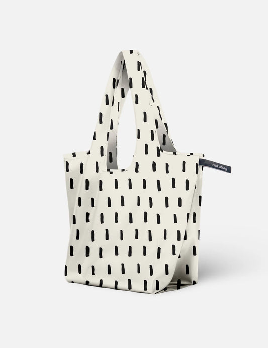 White tote bag with black abstract pattern on a white background