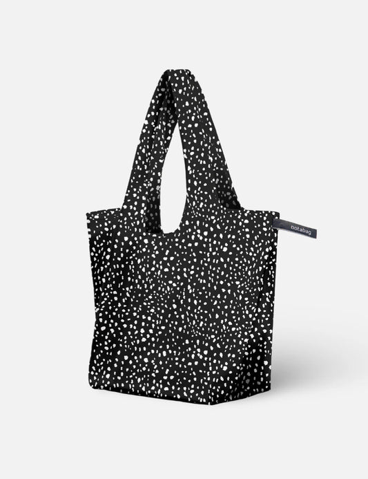 Black tote bag with white pattern on a light gray background