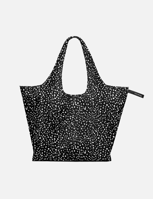 Black tote bag with white pattern on a light gray background