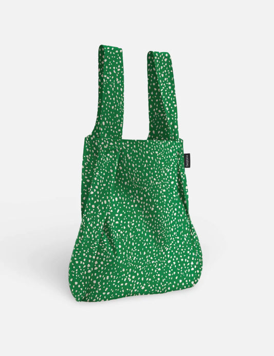 Green reusable shopping bag with white floral pattern on a white background