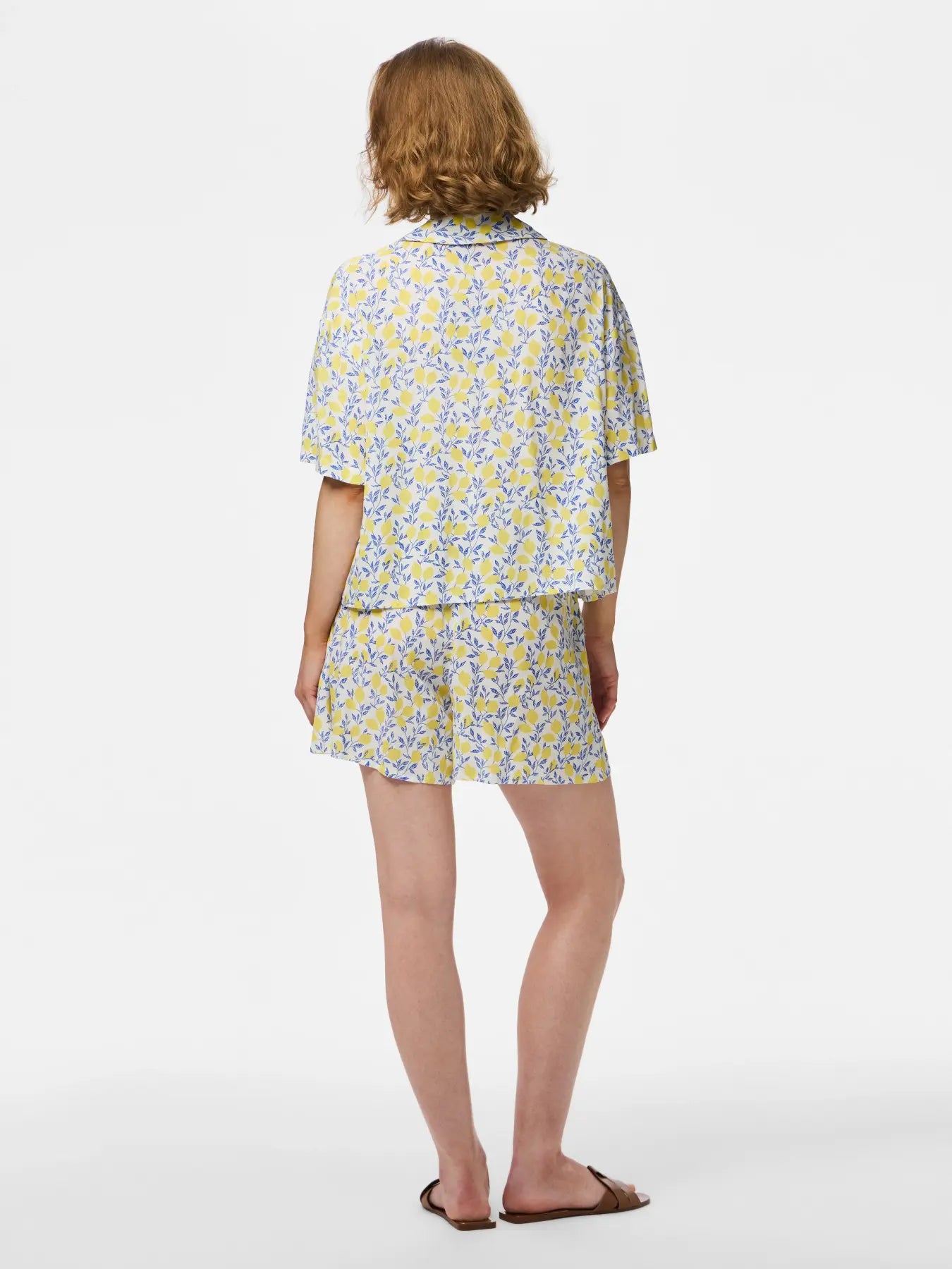 Woman wearing a floral outfit on a white background