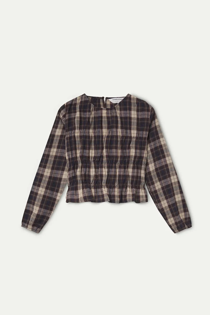 A long-sleeve cropped plaid top in dark brown and beige tones, laid flat against a light off-white background.