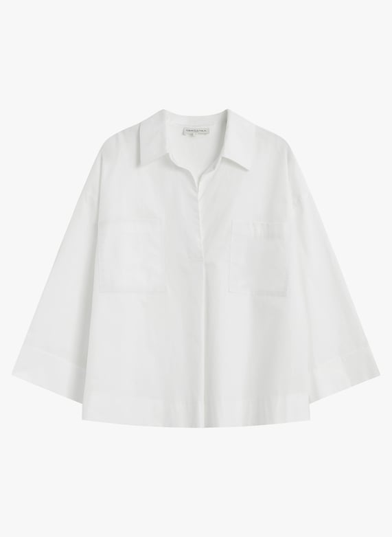 A white short-sleeve button-up shirt with a relaxed, oversized fit, featuring a pointed collar and two large patch pockets on the front, displayed against a clean white background.