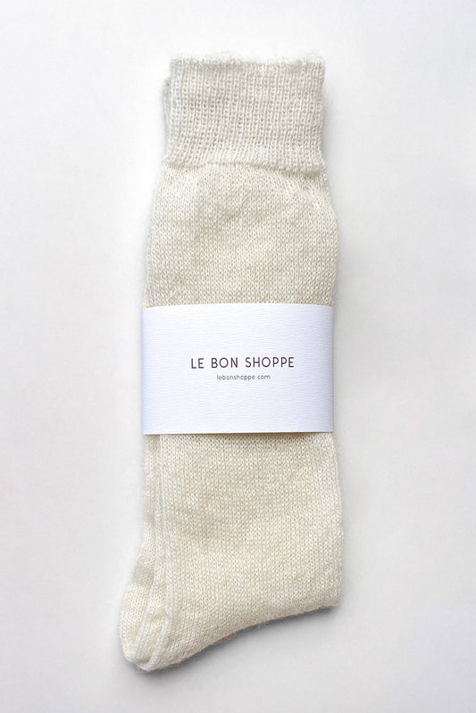 A single cream-colored knit sock with a white paper band label reading 'LE BON SHOPPE' on a clean white background.