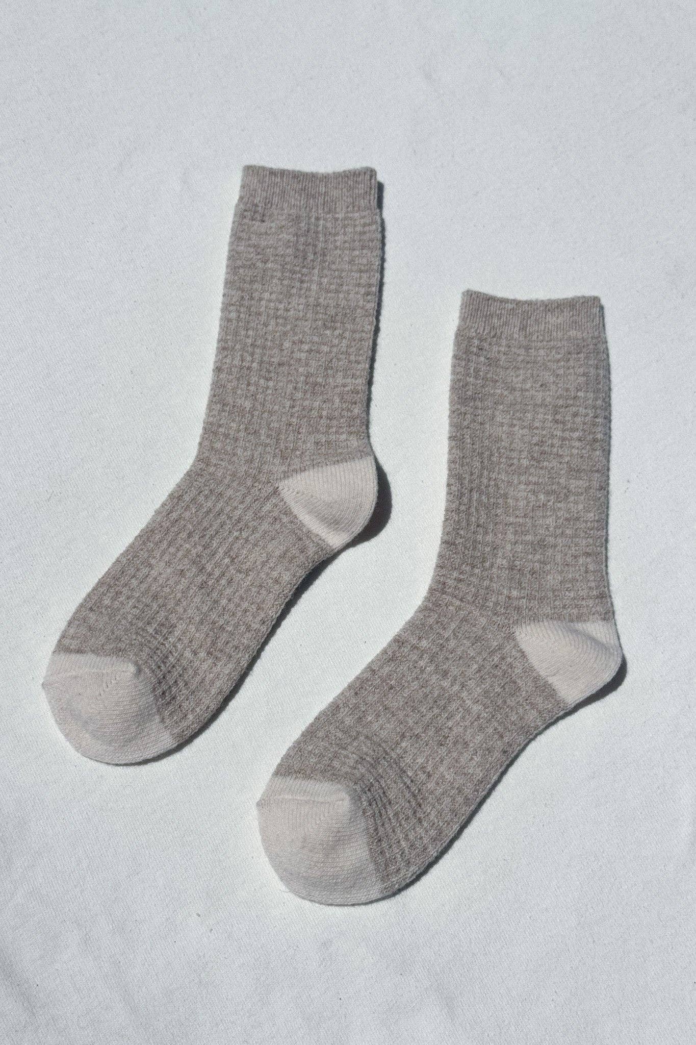 Pair of gray socks on a light gray background